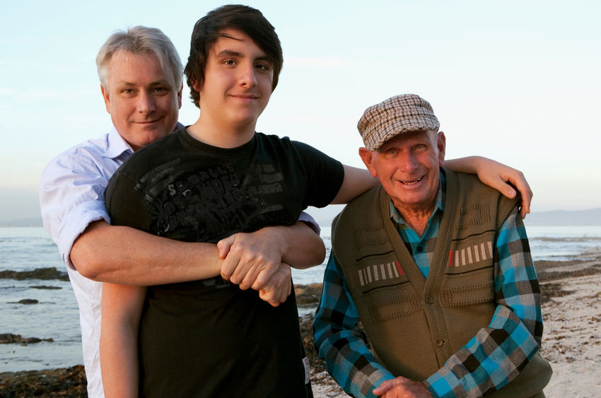 grandfather, father and son at the beach