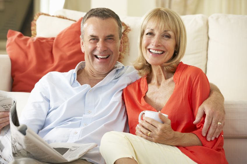 middle aged couple sitting in living room
