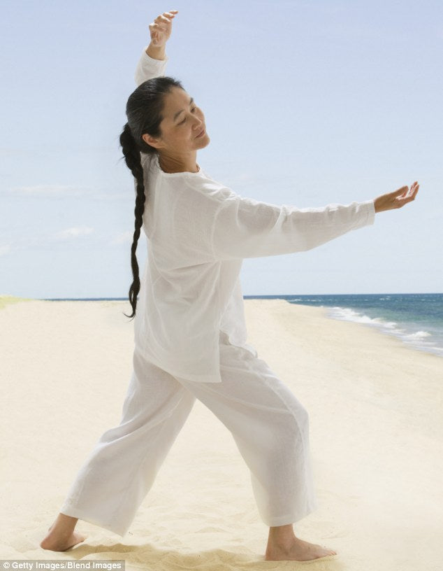 woman doing yoga on the beach