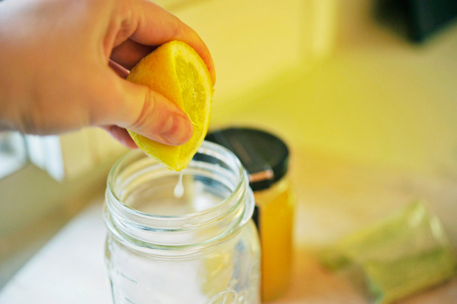 lemon being squeezed into water