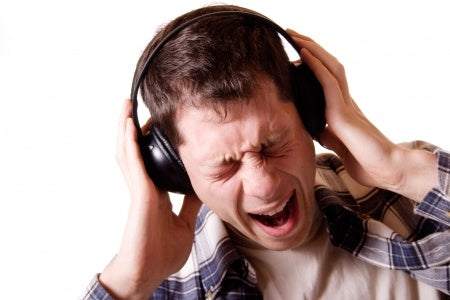 young man wearing headphones singing