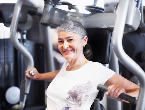 middle aged woman working out at the gym