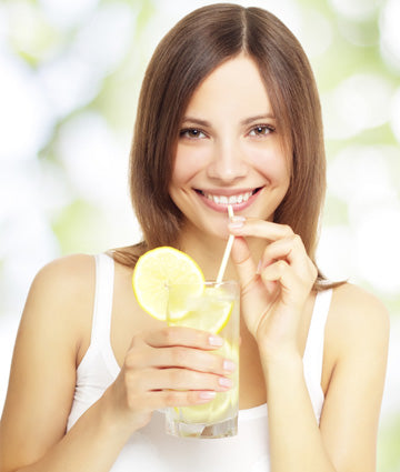 woman drinking water with lemon