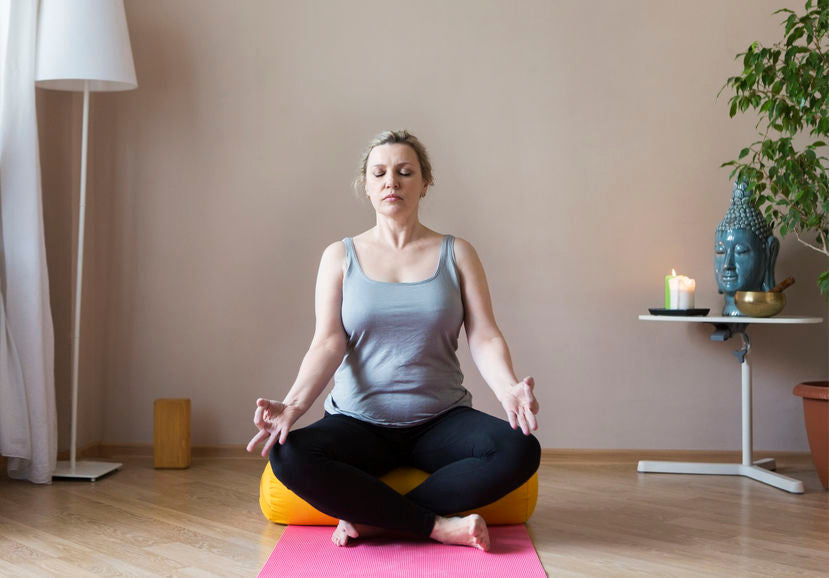 young woman in sukhasana pose