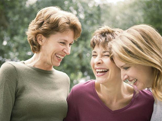 three female friends laughing
