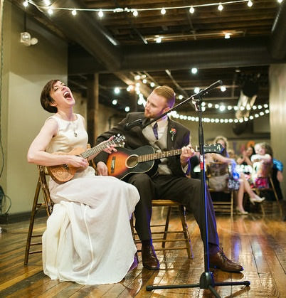 young couple performing with musical instruments