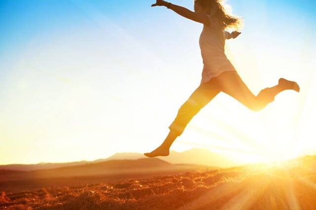 woman leaping in the sunlight
