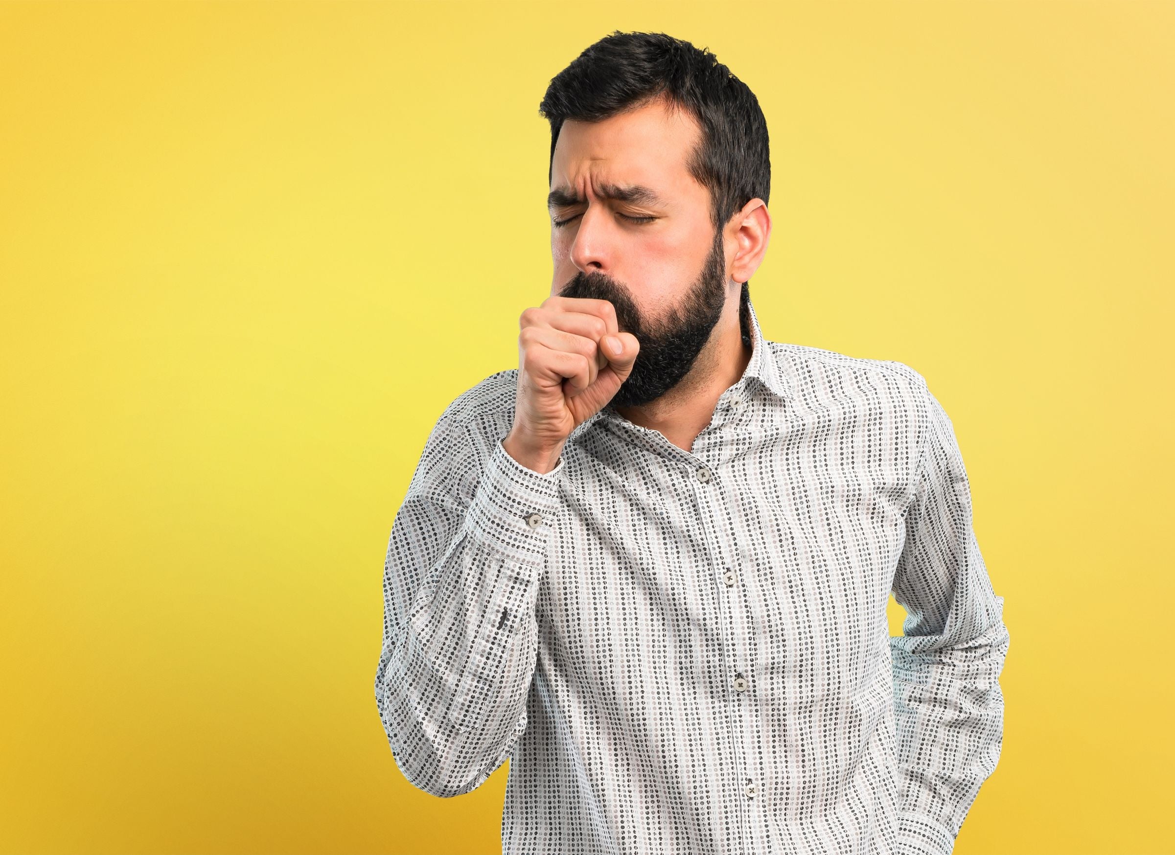 young bearded man coughing