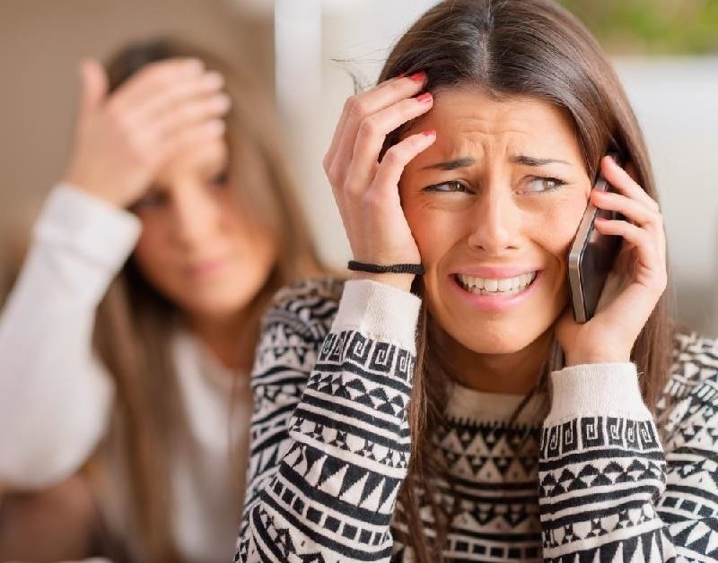 upset woman on the phone