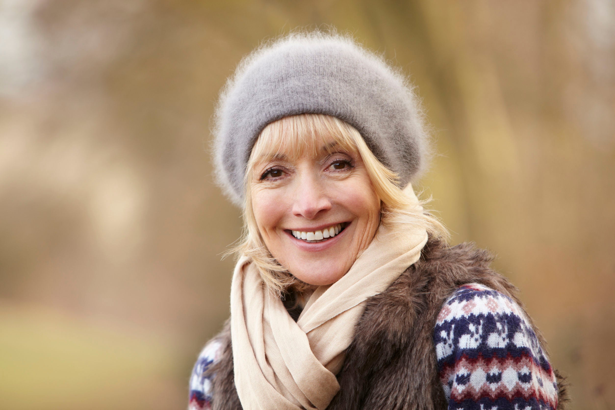 middle aged woman outside wearing a beanie and scarf